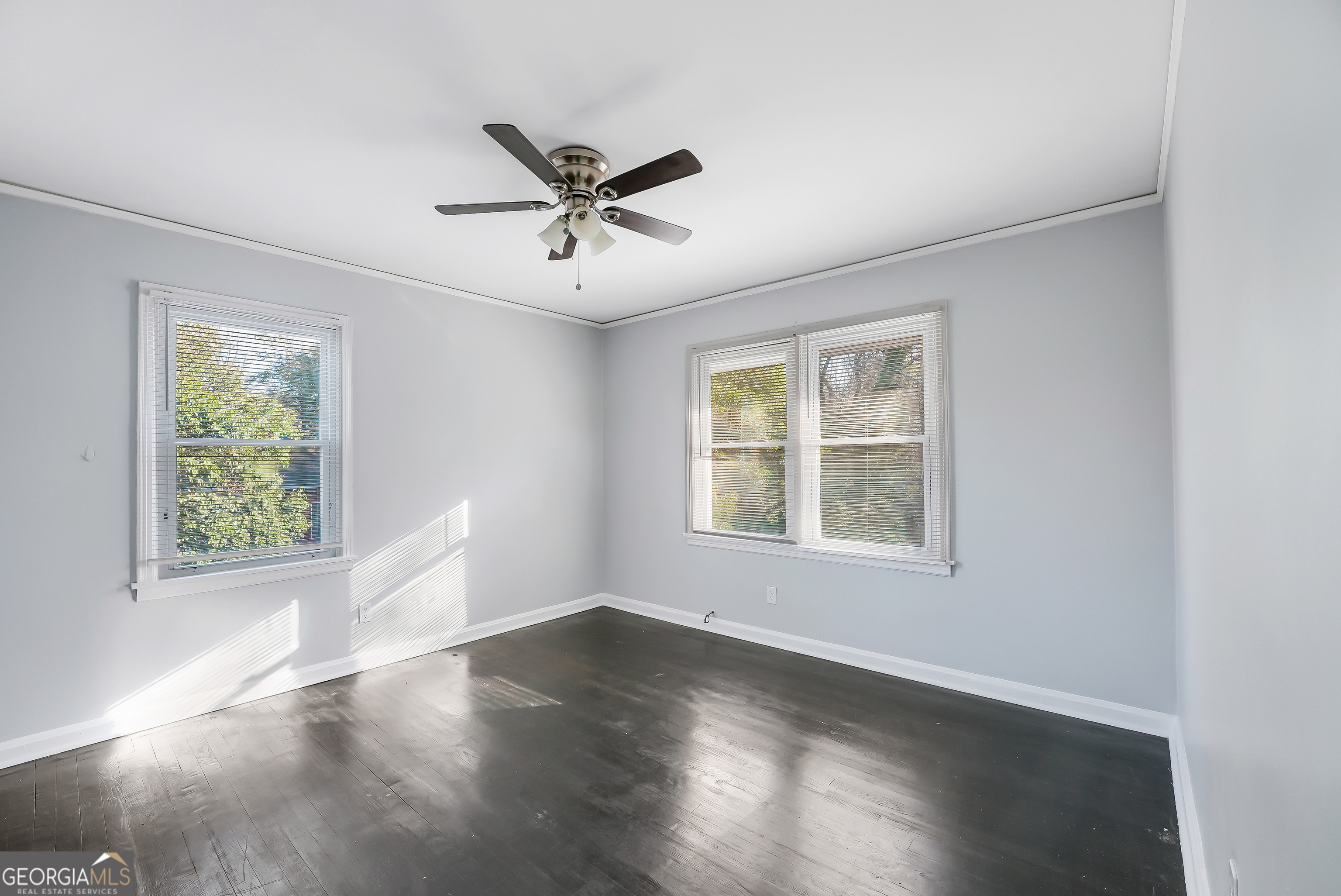 147 Burnside Street, Unit 4 Jonesboro, GA 30236 - Photo 4 of 9 a view of empty room with wooden floor and fan