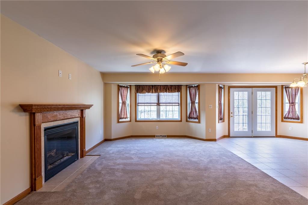 156 Chickadee Road Kittanning, PA 16201 - Photo 13 of 25 wooden floor fireplace and windows in an empty room