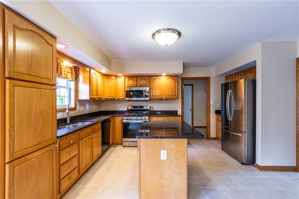 156 Chickadee Road Kittanning, PA 16201 - Photo 14 of 25 a kitchen with stainless steel appliances granite countertop a refrigerator a sink and a stove