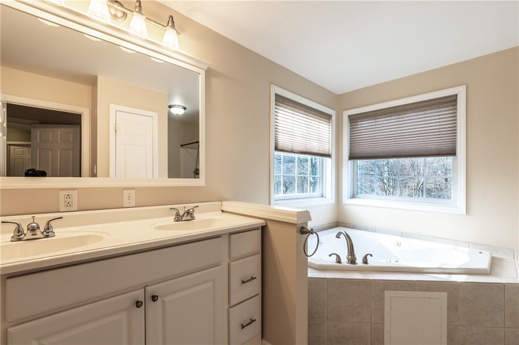 156 Chickadee Road Kittanning, PA 16201 - Photo 20 of 25 a bathroom with a tub sink and mirror