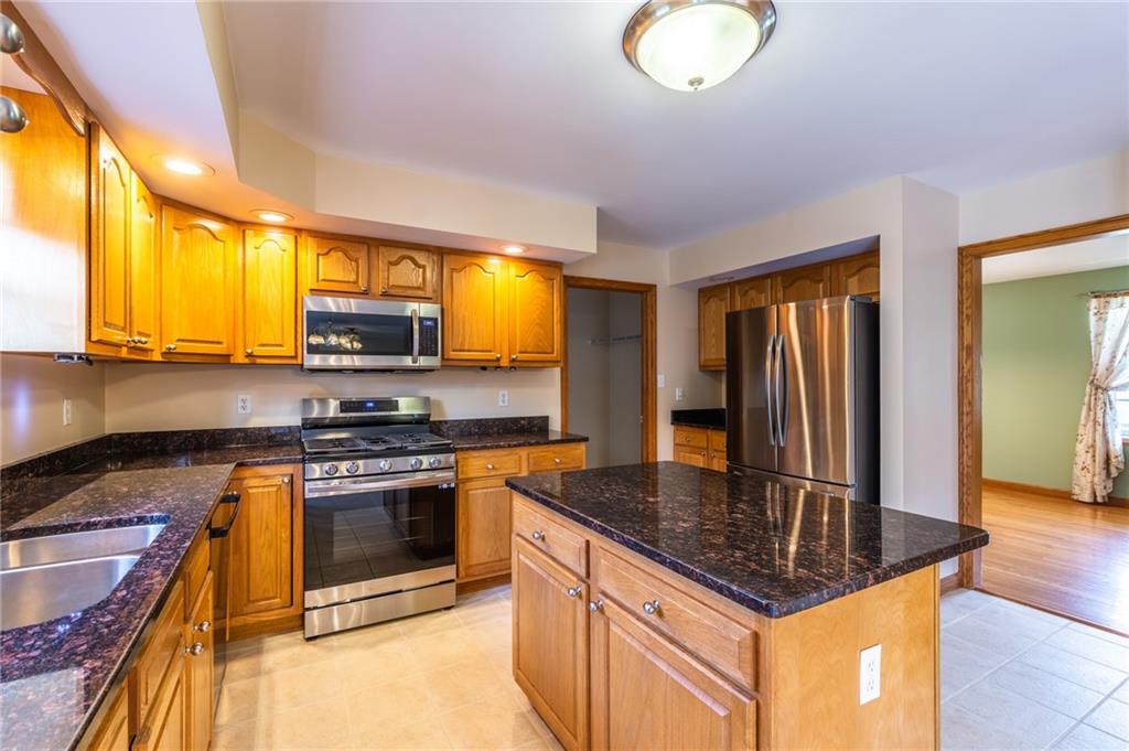156 Chickadee Road Kittanning, PA 16201 - Photo 10 of 25 a kitchen with stainless steel appliances granite countertop a stove a sink and a microwave