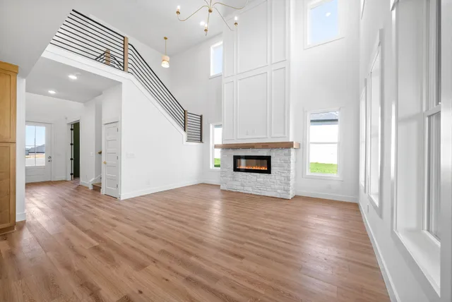 a view of empty room with wooden floor and fireplace