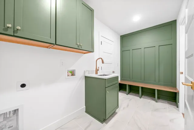 a room with washing machine and sink