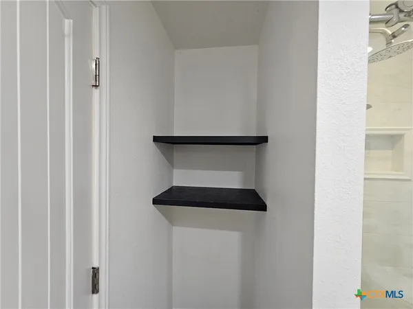 a bedroom with a large bed and a flat screen tv