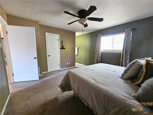 a bathroom with a granite countertop sink a mirror and a shower
