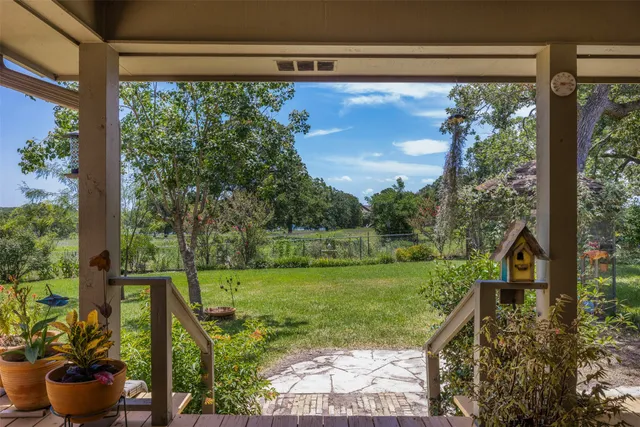 a view of a backyard with plants and a lake view