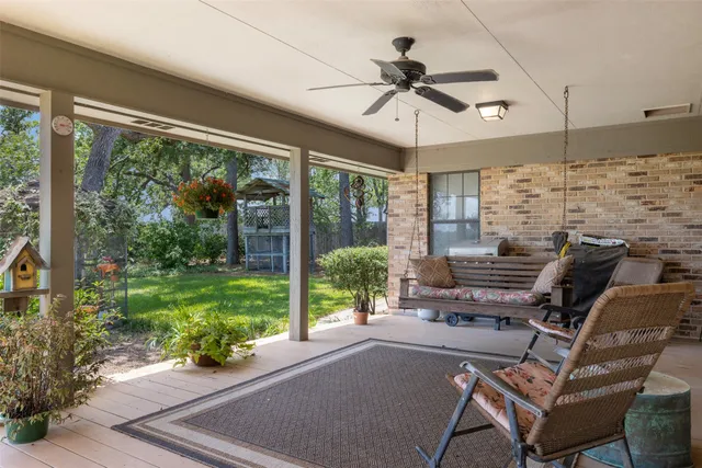 a living room with patio furniture and a floor to ceiling window