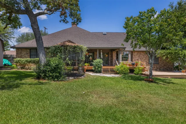a view of a house with backyard sitting area and garden