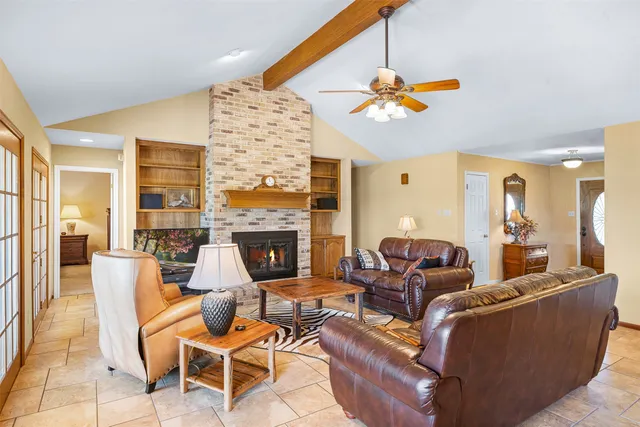 a living room with fireplace furniture and a chandelier