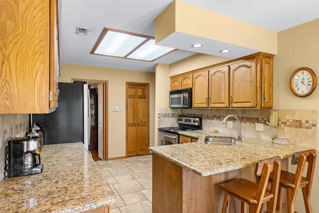 a kitchen with a sink a stove and a refrigerator