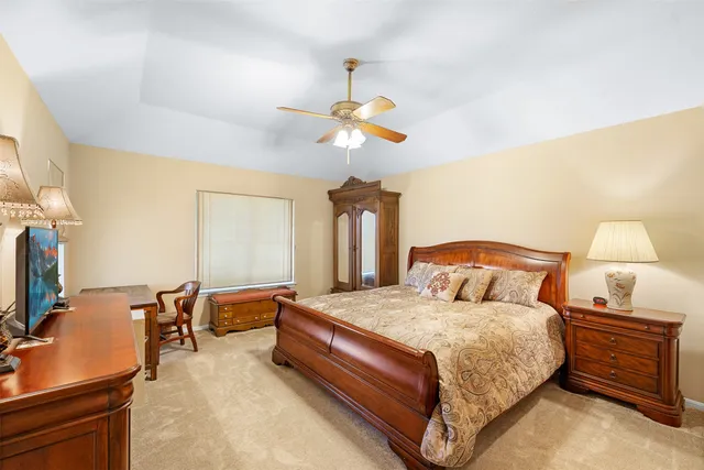 a bedroom with bed and a chandelier