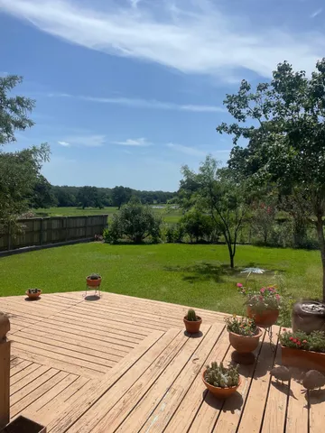 a view of a deck and yard