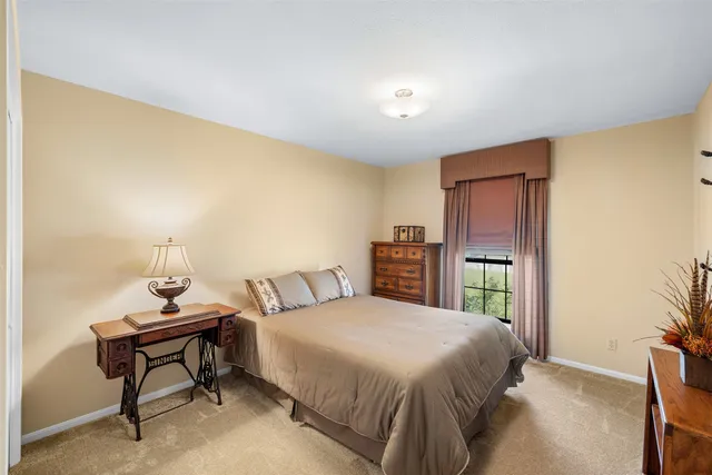 a bedroom with a bed and a chair