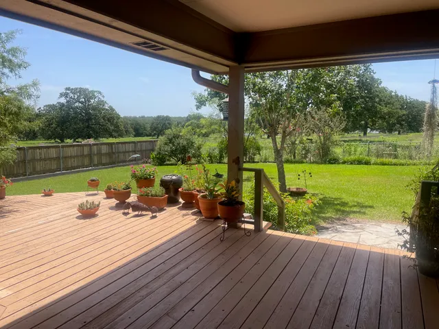 a view of a lake with wooden floor and outdoor space