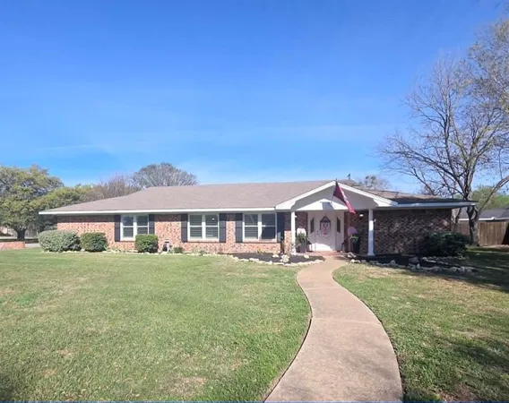 a front view of a house with a yard porch and outdoor seating