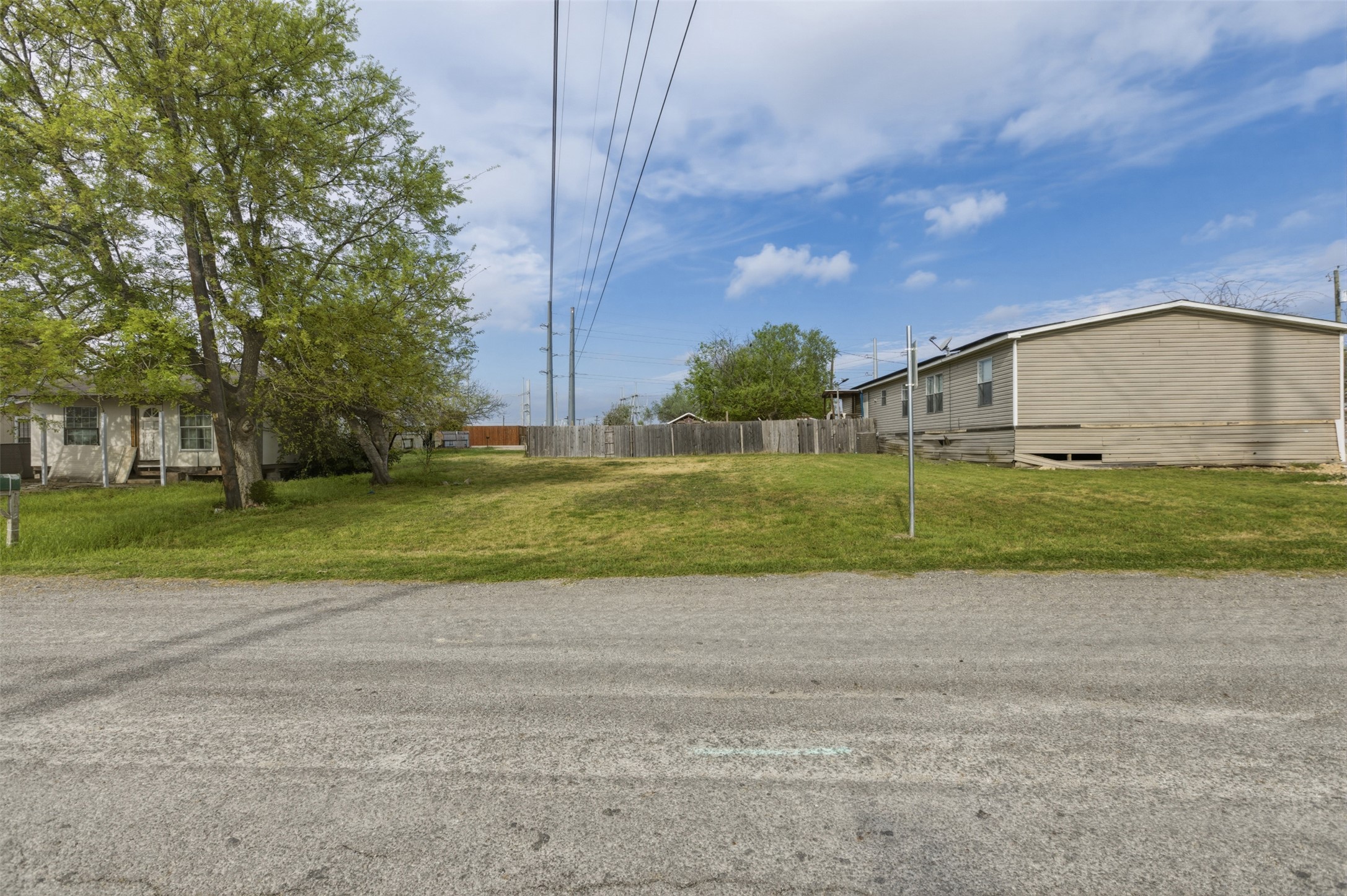 104 Royal Street Taylor, TX 76574 - Photo 15 of 21 a view of a house with a big yard and large trees