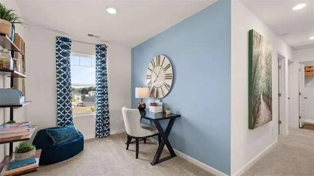 a view of a workspace with furniture and a window