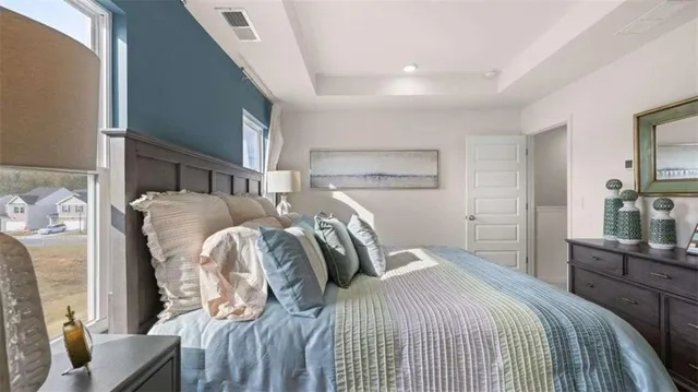a bedroom with a bed and dresser