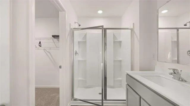 a bathroom with a shower sink and mirror
