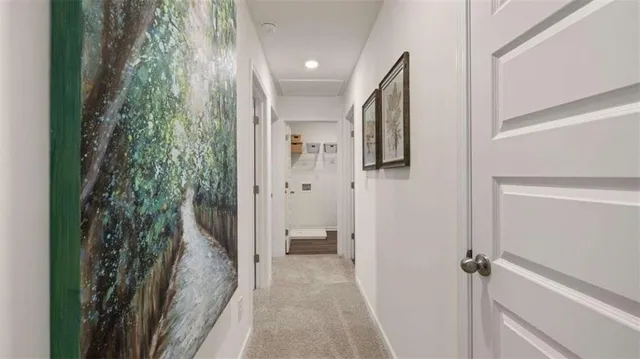 a view of a hallway with closet and wooden floor