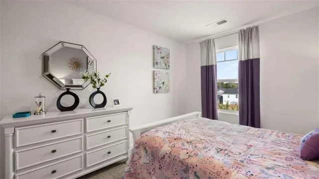 a bedroom with a bed and cabinets