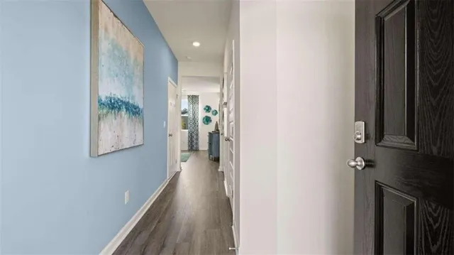 a view of hallway with stairs and wooden floor
