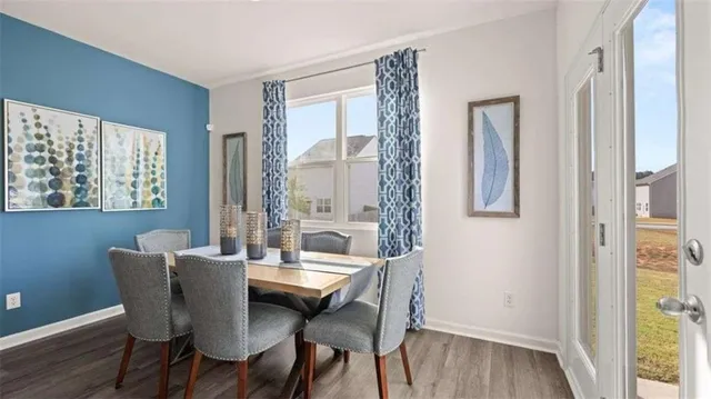 a view of a dining room with furniture window and wooden floor