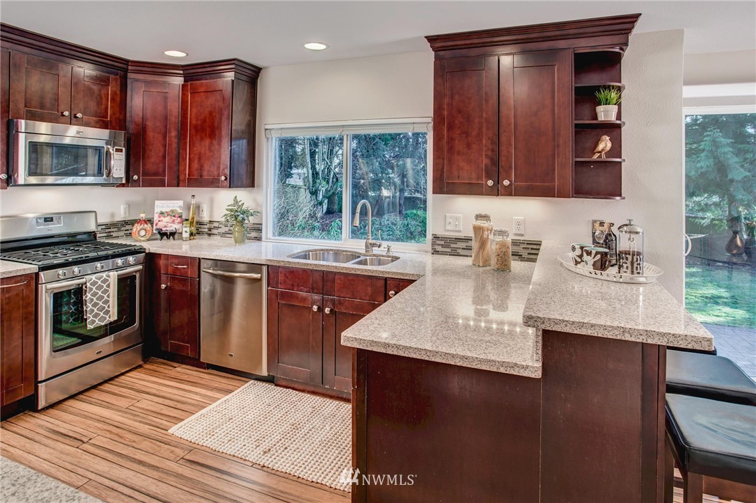 23613 Meridian Place West Bothell, WA 98021 - Photo 14 of 32 a kitchen with a sink stove and cabinets