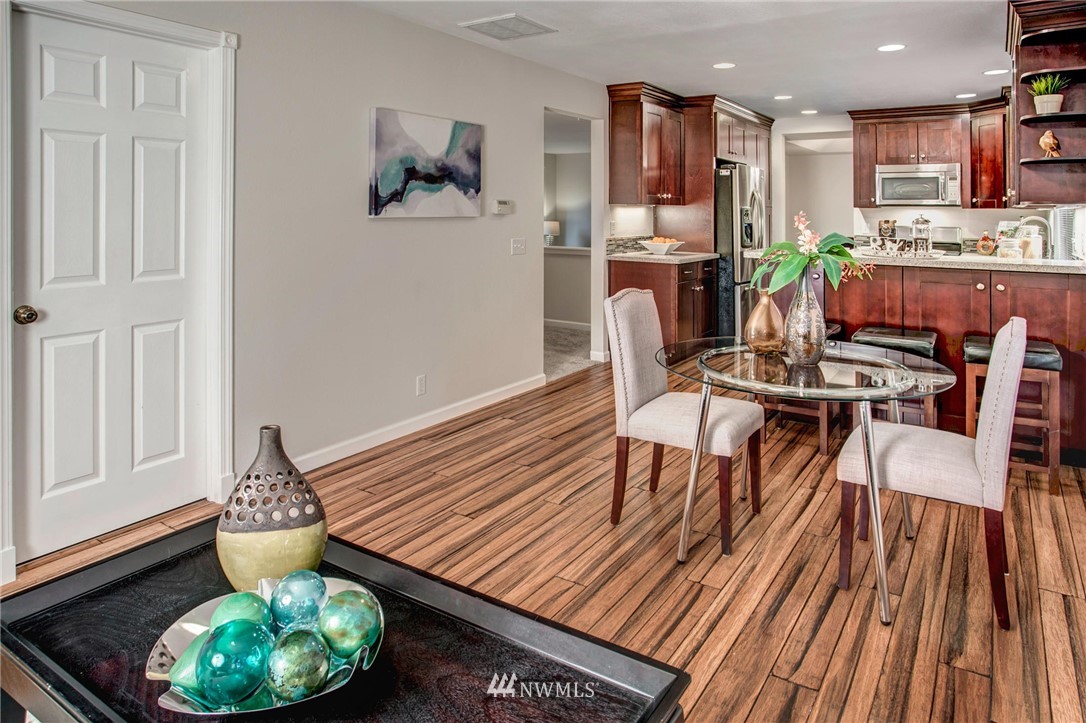 23613 Meridian Place West Bothell, WA 98021 - Photo 17 of 32 a dining room with furniture a rug and wooden floor