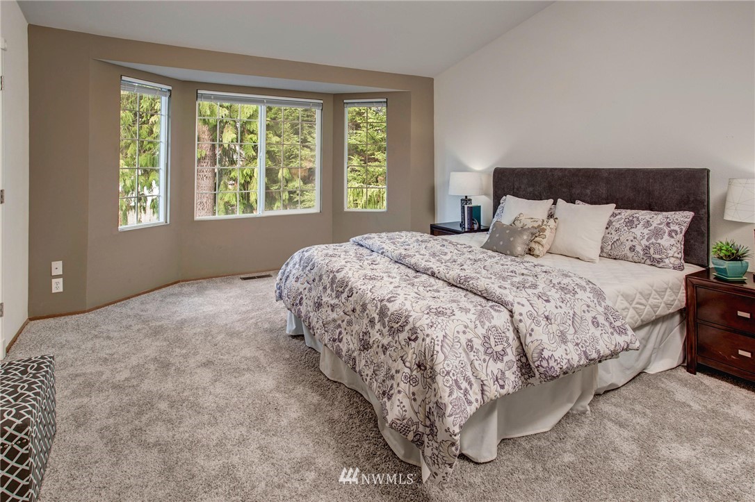 23613 Meridian Place West Bothell, WA 98021 - Photo 23 of 32 a large bed sitting in a bedroom next to a window