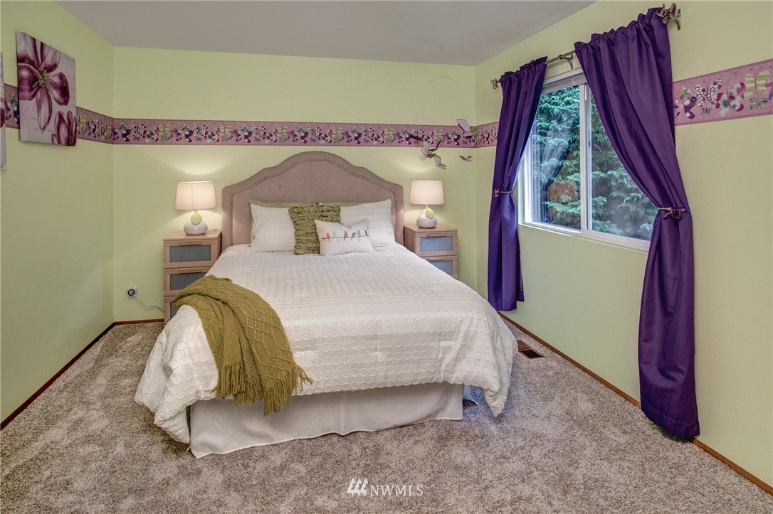 23613 Meridian Place West Bothell, WA 98021 - Photo 27 of 32 a bedroom with a bed and a window