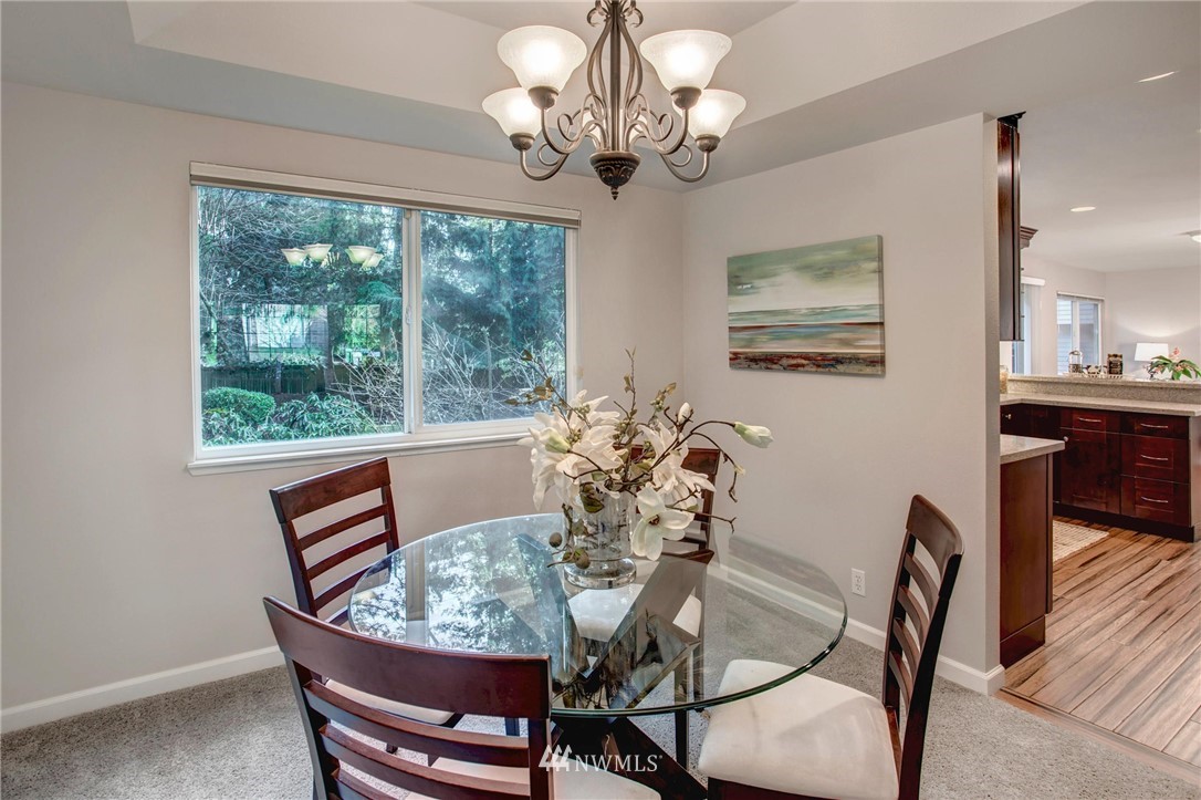 23613 Meridian Place West Bothell, WA 98021 - Photo 10 of 32 a view of a dining room with furniture a chandelier and wooden floor