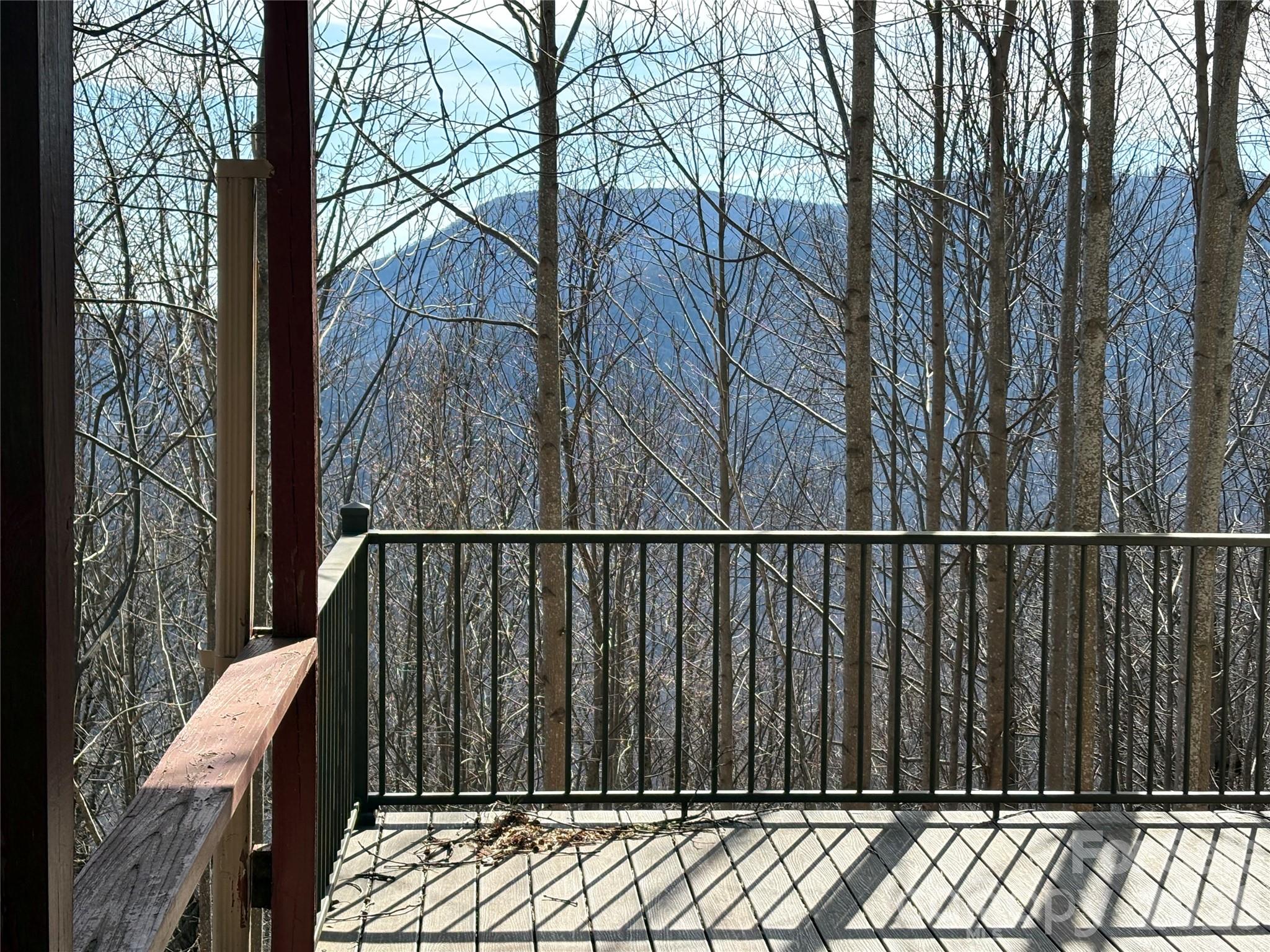 700 Summit Road Tryon, NC 28782 - Photo 1 of 27 a view of balcony with wooden fence and trees