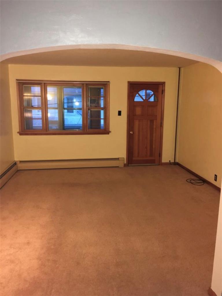 69 West Ridge Street Nesquehoning, PA 18240 - Photo 3 of 8 A well-lit entry or living area awaits your personal touch with soft carpeting and arched doorways.