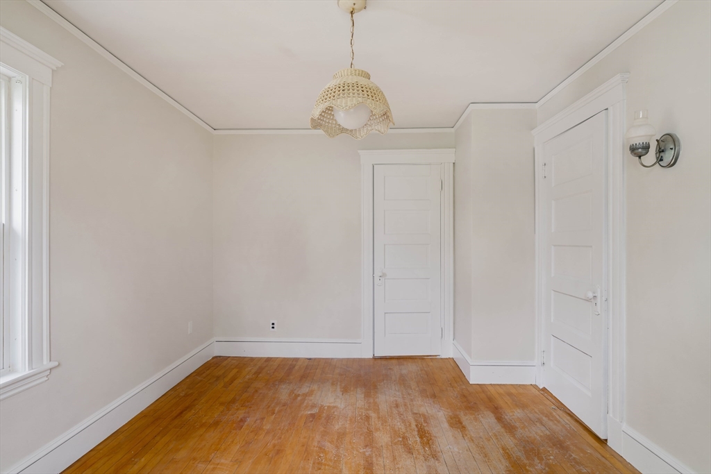 21 Perkins Avenue Boston, MA 02136 - Photo 15 of 26 a view of a room with wooden floor and white walls