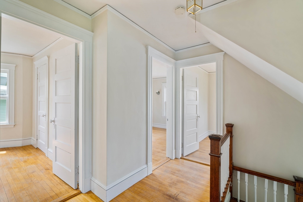 21 Perkins Avenue Boston, MA 02136 - Photo 16 of 26 a view of a hallway to a room with wooden floor and staircase