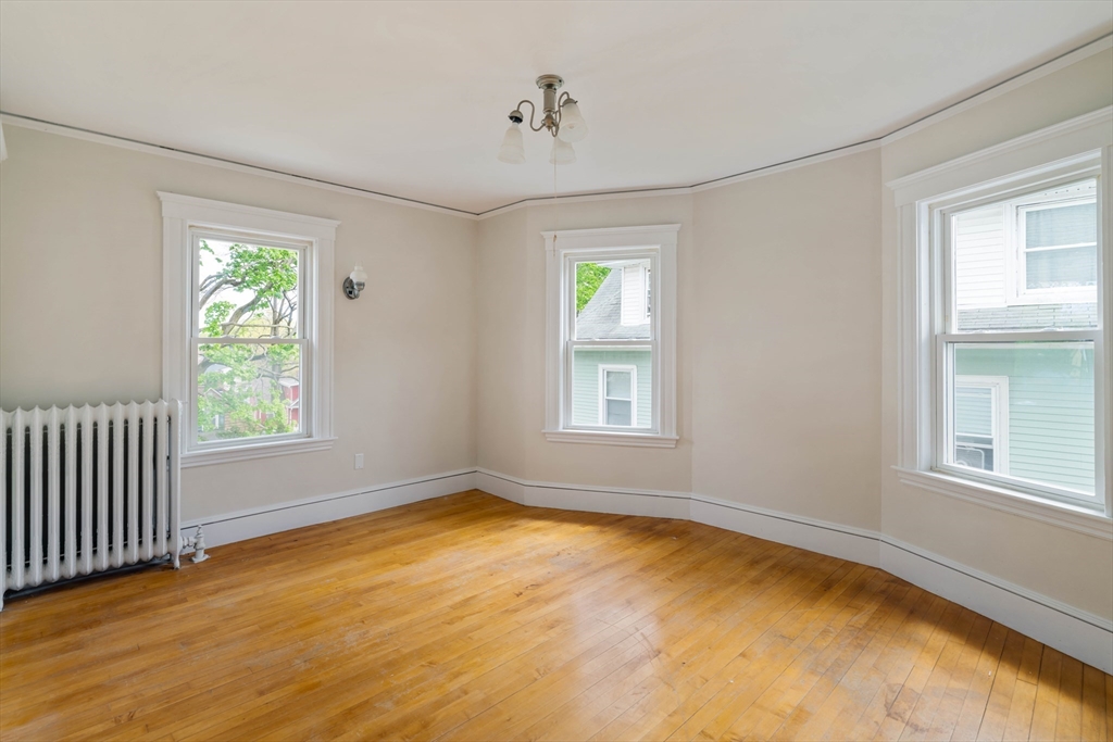 21 Perkins Avenue Boston, MA 02136 - Photo 17 of 26 a view of empty room with wooden floor and fan