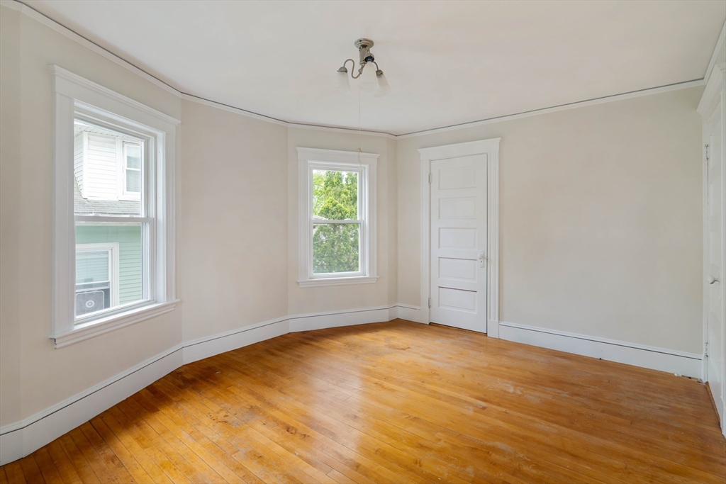 21 Perkins Avenue Boston, MA 02136 - Photo 18 of 26 a view of empty room with wooden floor and fan