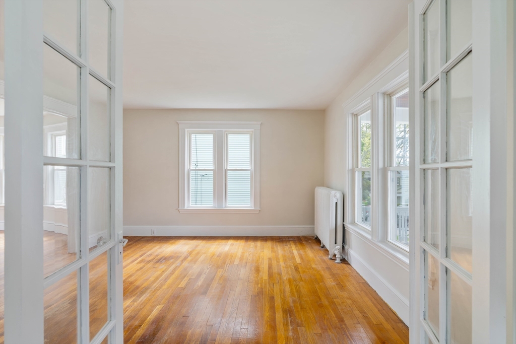 21 Perkins Avenue Boston, MA 02136 - Photo 3 of 26 a view of empty room with wooden floor and fan