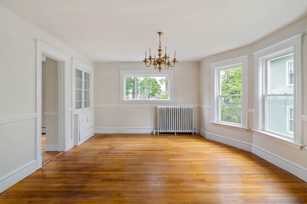 21 Perkins Avenue Boston, MA 02136 - Photo 6 of 26 a view of an empty room with wooden floor and a window