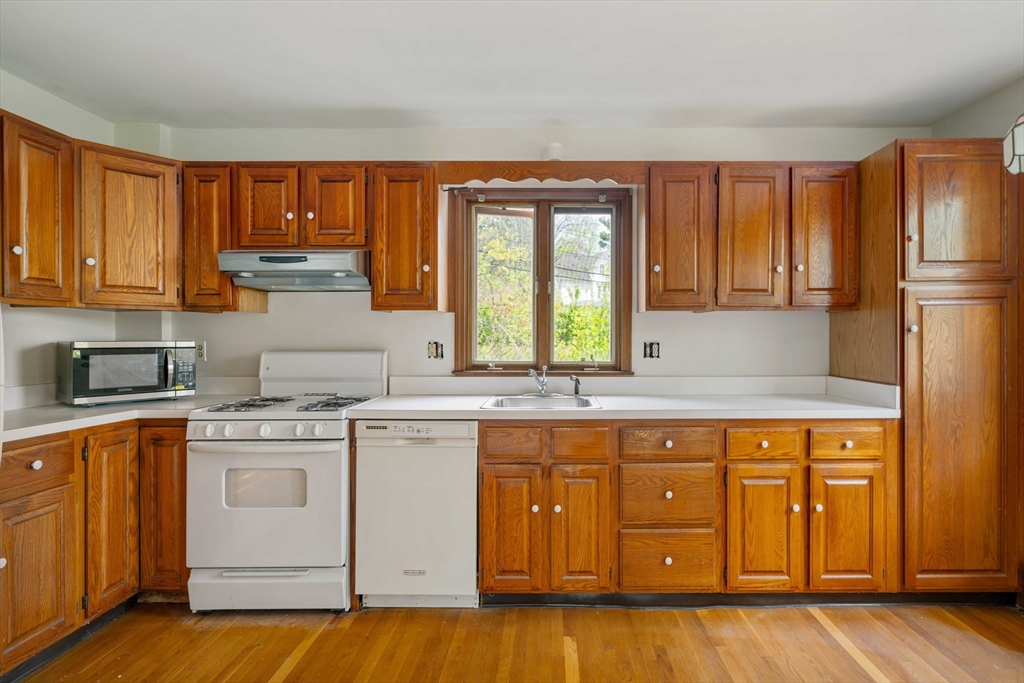 21 Perkins Avenue Boston, MA 02136 - Photo 8 of 26 a kitchen with a stove a sink and a refrigerator