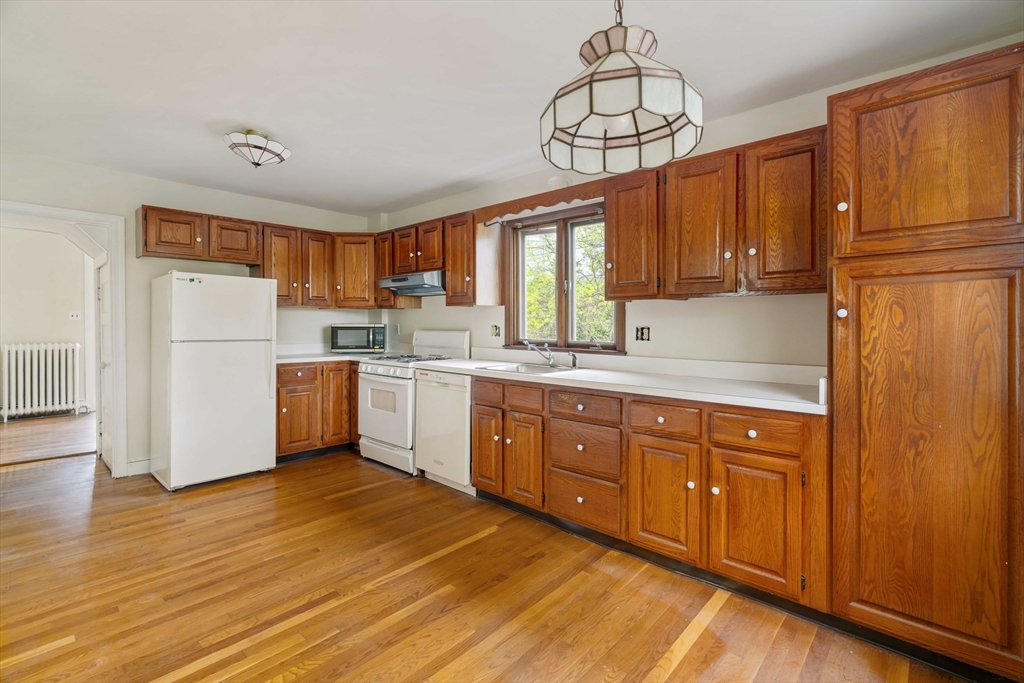 21 Perkins Avenue Boston, MA 02136 - Photo 10 of 26 a kitchen with wooden cabinets and white appliances