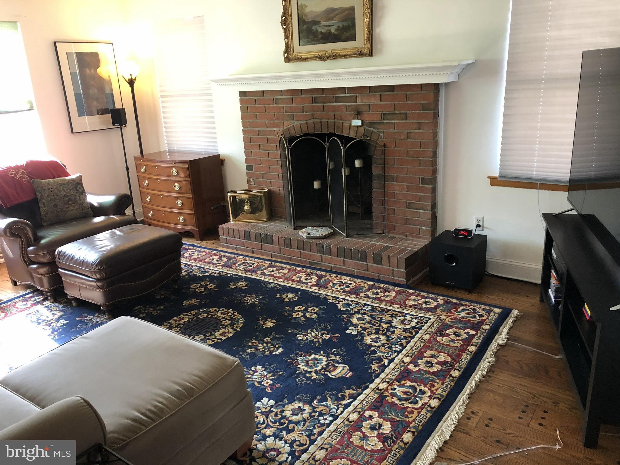 904 Litchfield Road Baltimore, MD 21239 - Photo 11 of 13 a living room with furniture and a fireplace