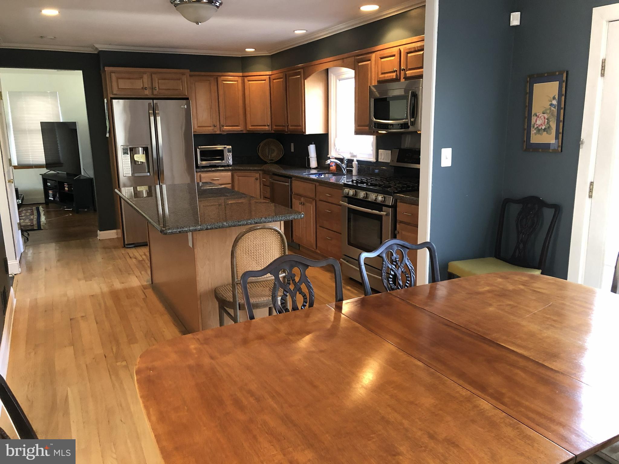904 Litchfield Road Baltimore, MD 21239 - Photo 12 of 13 a kitchen with stainless steel appliances kitchen island granite countertop a refrigerator and cabinets