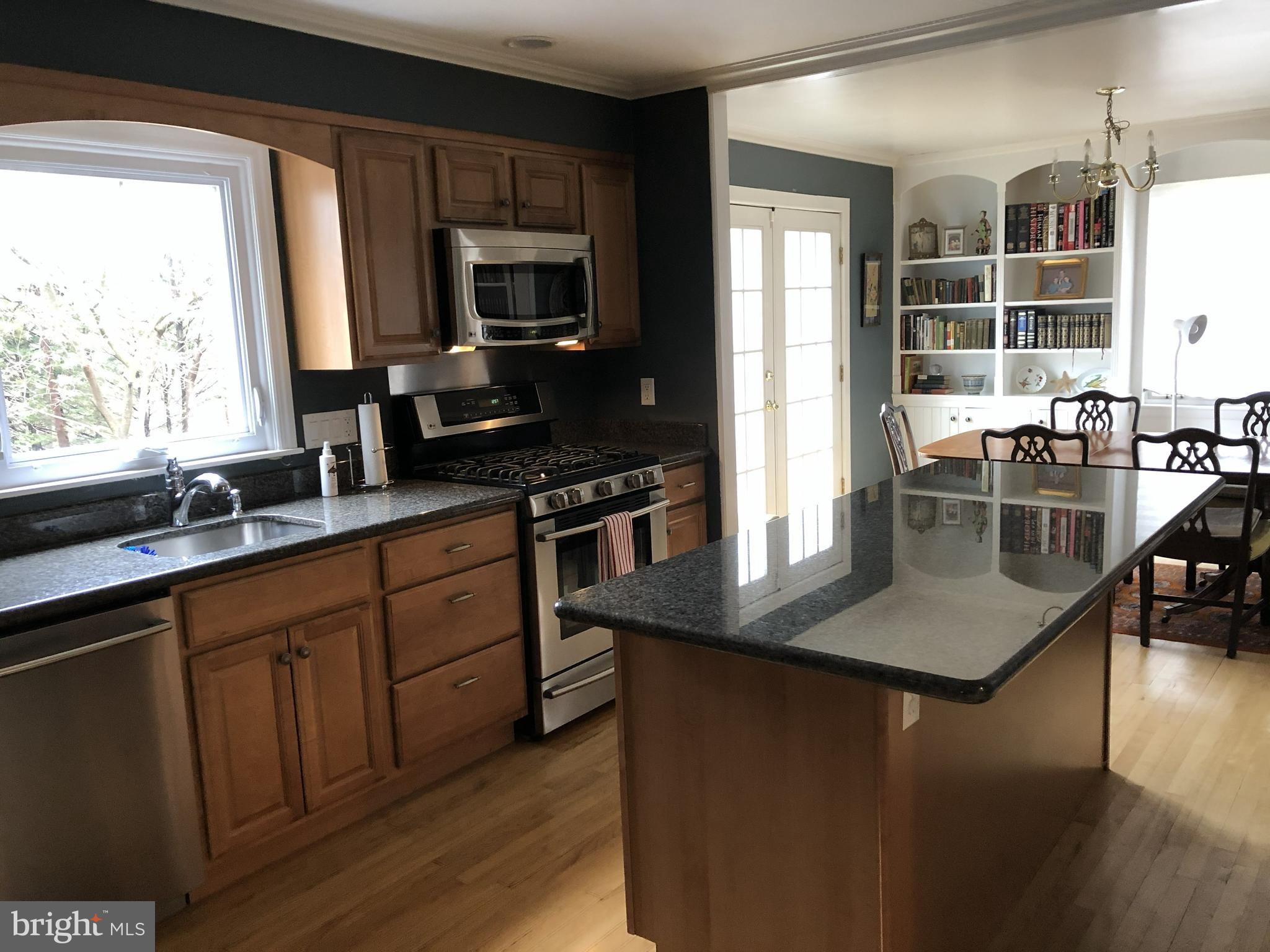 904 Litchfield Road Baltimore, MD 21239 - Photo 13 of 13 a kitchen with stainless steel appliances granite countertop a stove a sink a microwave and a refrigerator