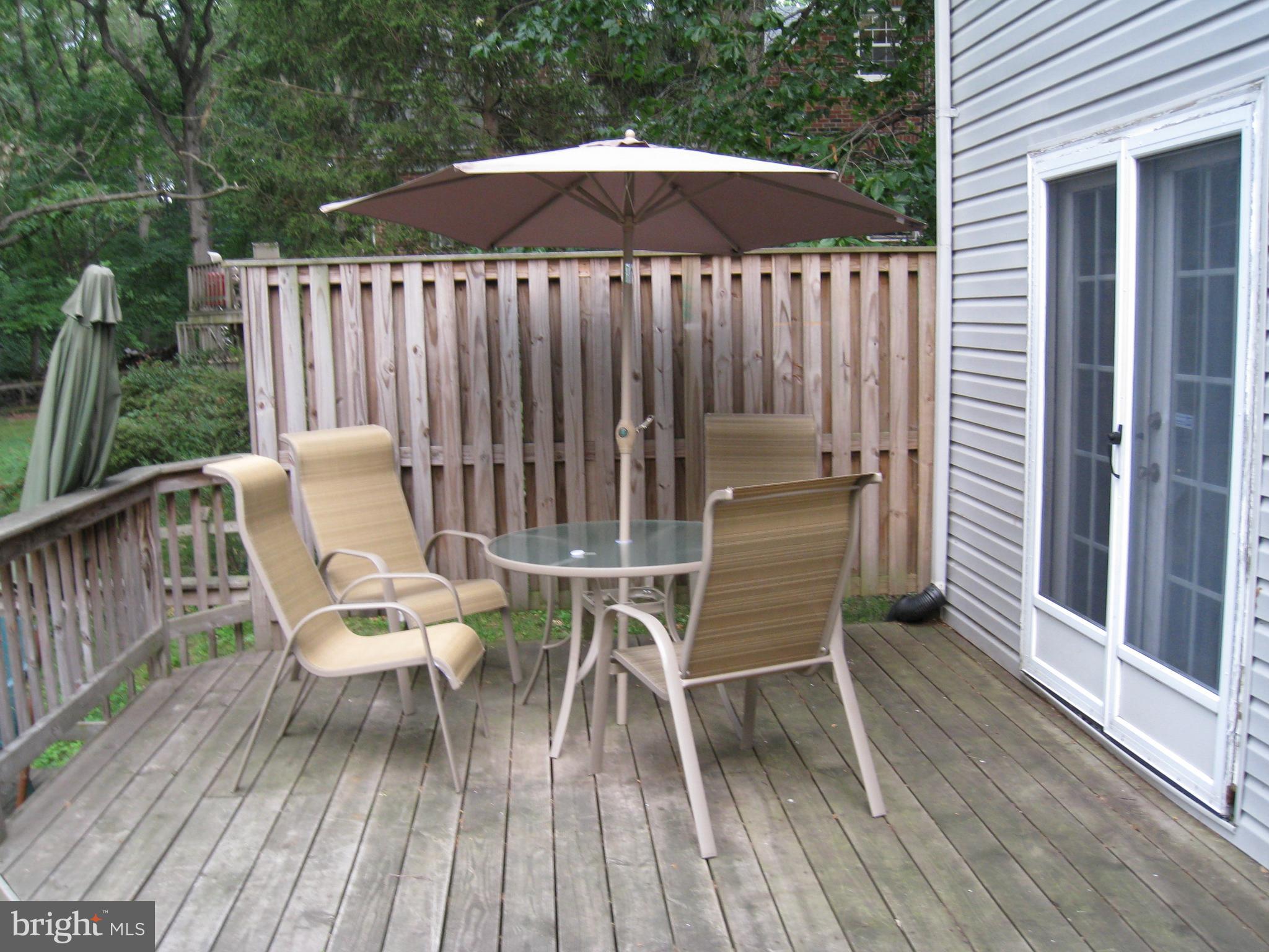 904 Litchfield Road Baltimore, MD 21239 - Photo 8 of 13 a lawn chairs sitting on a wooden deck