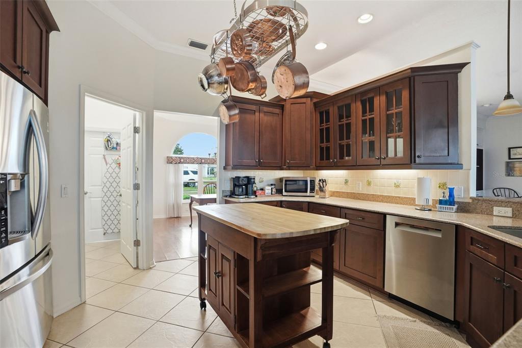 14228 Presteign Lane Spring Hill, FL 34609 - Photo 24 of 89 a kitchen with stainless steel appliances granite countertop a sink a stove and a refrigerator