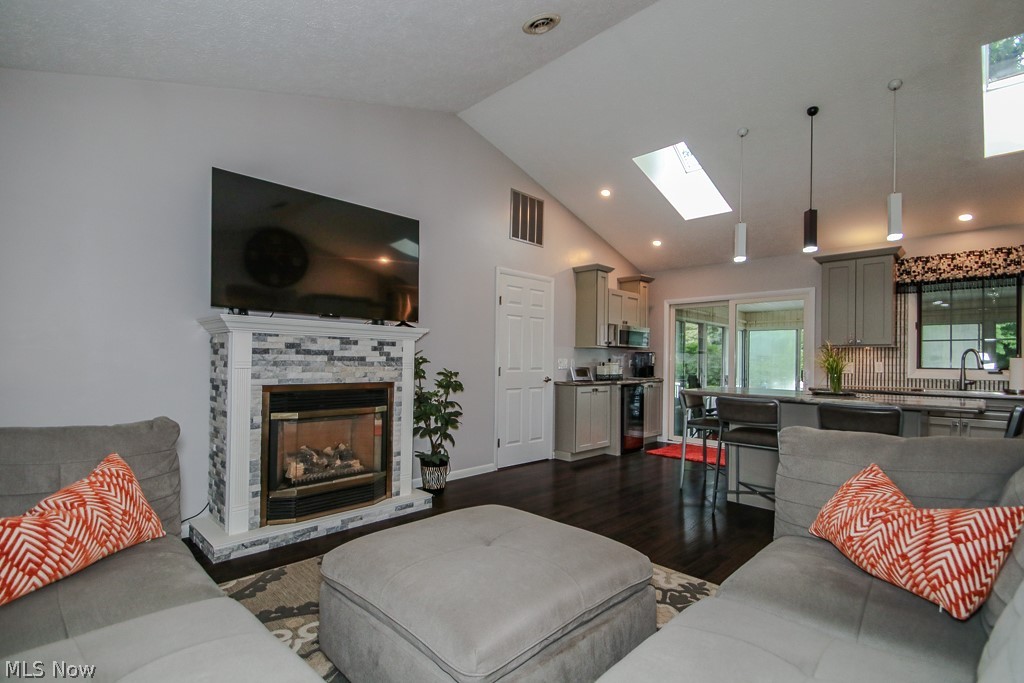1966 Spring Grove Madison, OH 44057 - Photo 7 of 50 Vaulted Ceilings, Gas Fireplace and separate beverage kitchen is perfect for today's lifestyles
