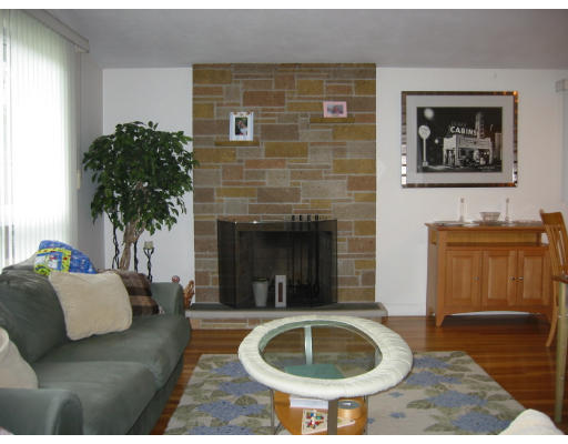 11 Daley Street Needham, MA 02494 - Photo 3 of 6 a living room with furniture and a fireplace