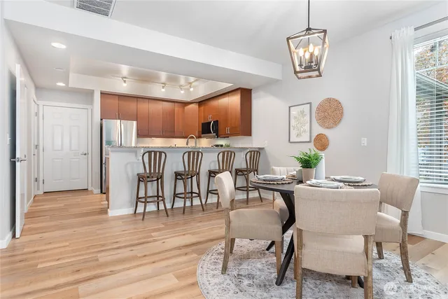 a dining room with furniture a window and wooden floor